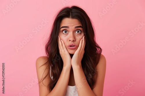 Nervous Latin woman in studio with oops reaction to gossip on pink background. Mistake, sorry and female overwhelmed by fake news