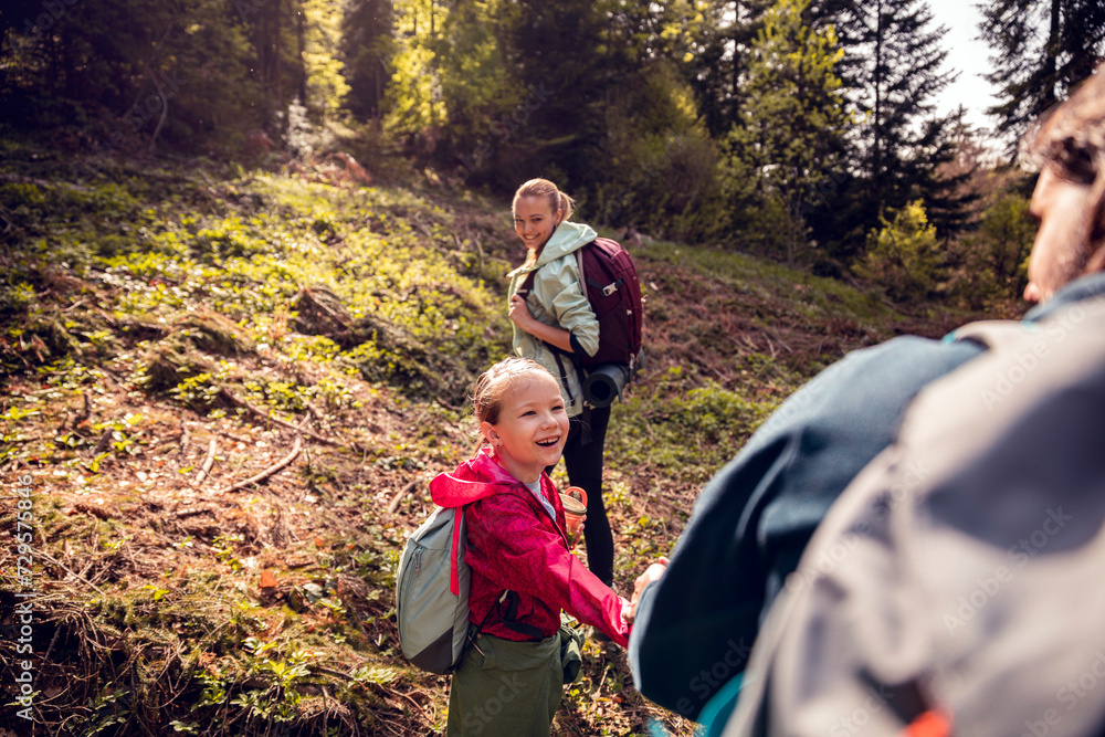 Young family hiking through the woods Young family hiking through the woods