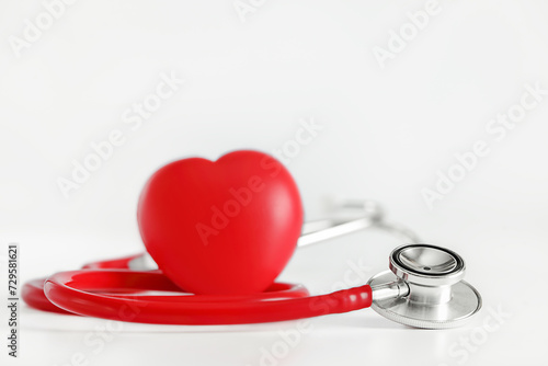 red stethoscope and red heart on white background