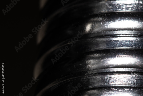 Quadro em tela Close up of the thread of a metallic screw on black background, textured metal,