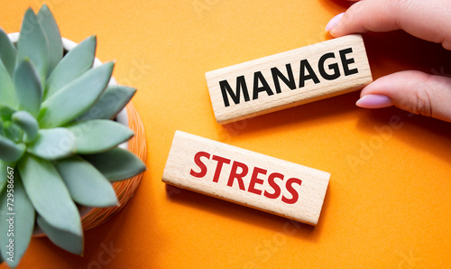 Manage stress symbol. Concept word Manage stress on wooden blocks. Businessman hand. Beautiful orange background with succulent plant. Business and Manage stress concept. Copy space