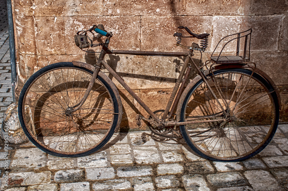 old bicycle leaned on facade. old bicycle leaned on facade.