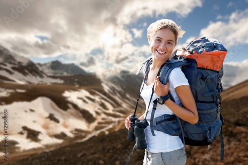 Woman hold backpack at mountain range, hiking tourist