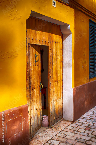 Facade and wooden door in mallorquin style. photo