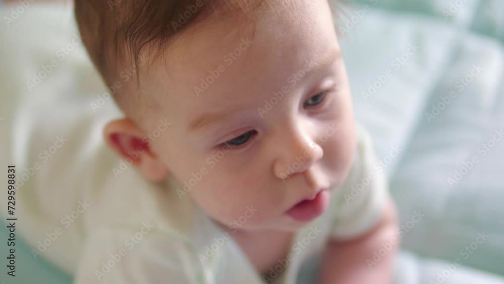 Cute baby with hair lying on tummy in 4k slow motion 60fps Cute baby with hair lying on tummy in 4k slow motion 60fps