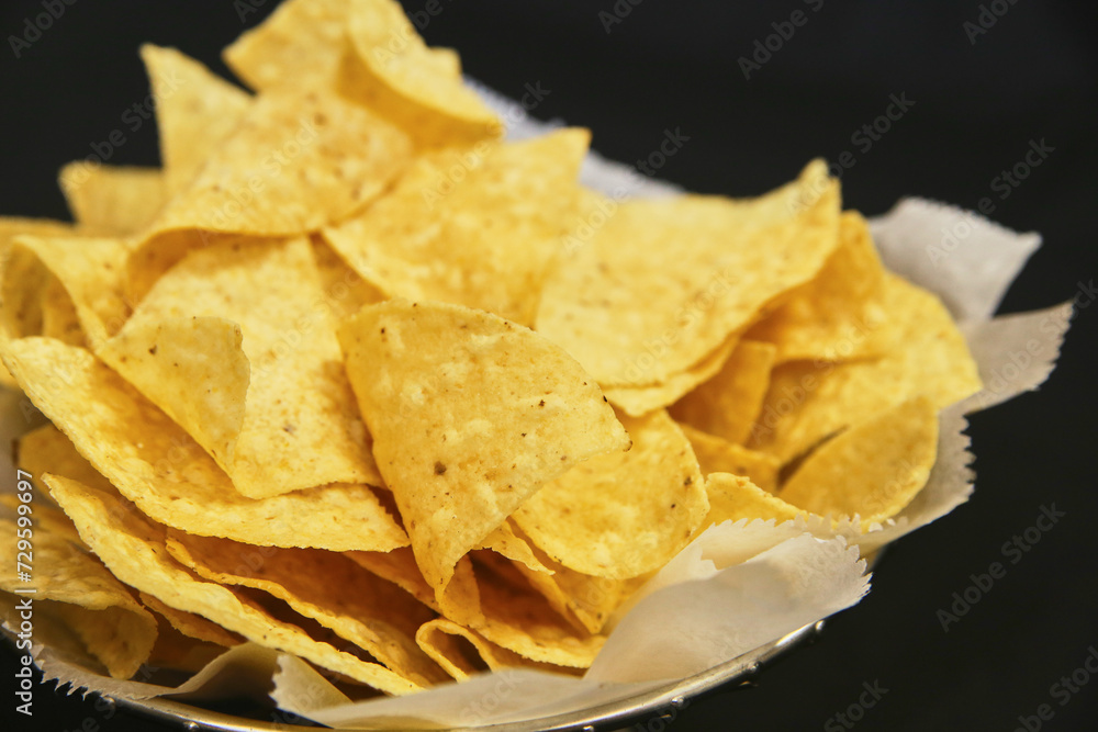 Crispy Golden Tortilla Chips Close-Up on Black Background Crispy Golden Tortilla Chips Close-Up on Black Background