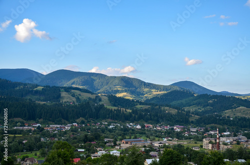 Picturesque summer landscape of the village of Verkhovyna with numerous small houses located in a valley among mountains and hills. Carpathians, Ukraine