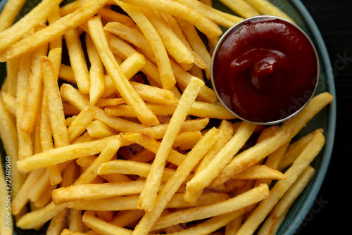Homemade French Fries with Ketchup on a Plate, top view. Close-up.