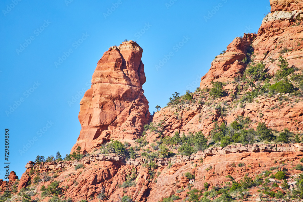 Sedona Red Rock Spire with Greenery under Blue Sky