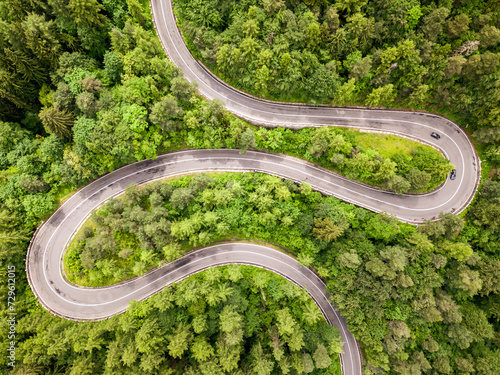 Fototapeta Naklejka Na Ścianę i Meble -  Aerial view of a road in the middle of the forest