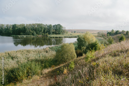 A picturesque landscape with a pond near the village.