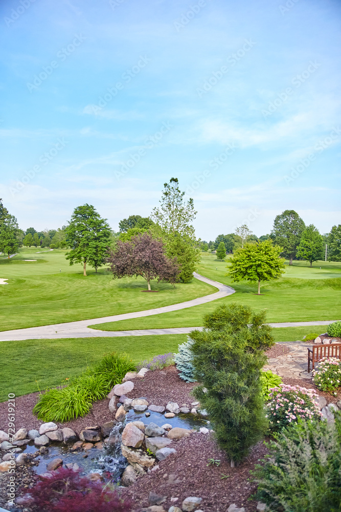 Naklejka premium Morning Serenity at Golf Course with Landscaped Garden and Pond