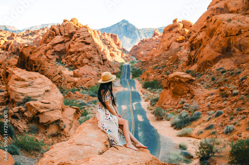 Photography Rear view of elegant woman at famous viewpoint overlooking the Valley of Fire State Park in Mojave desert, Nevada, USA