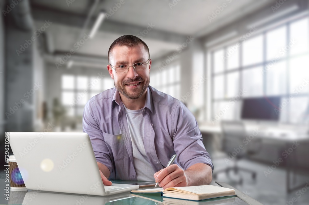Portrait of attractive business man in office at work Portrait of attractive business man in office at work