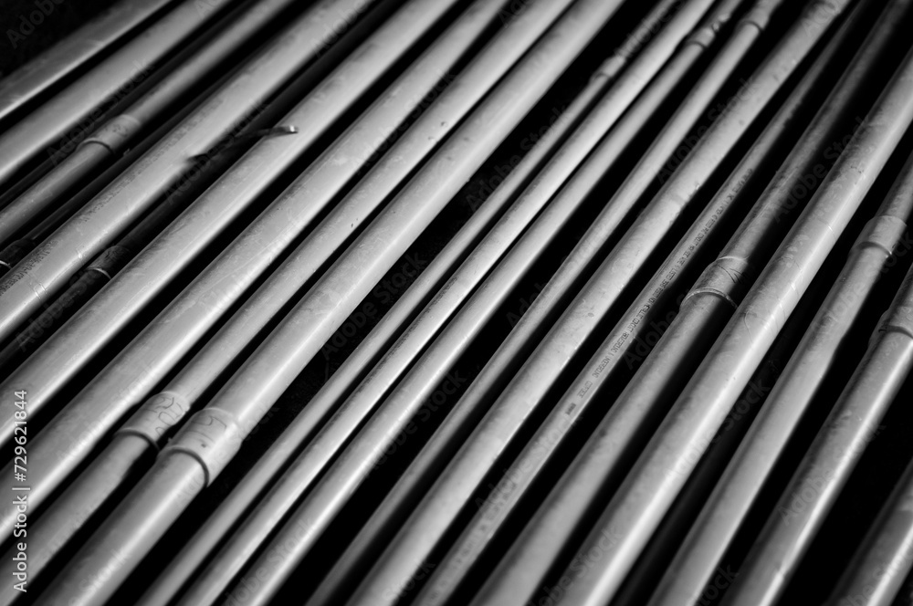 Obraz premium A close up image of gray conduits in a stack. Good background for electrical, construction or industry. 