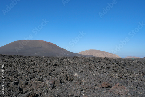 The volcanic mountain landscape of Lanzarote, Spain, under a clear sky