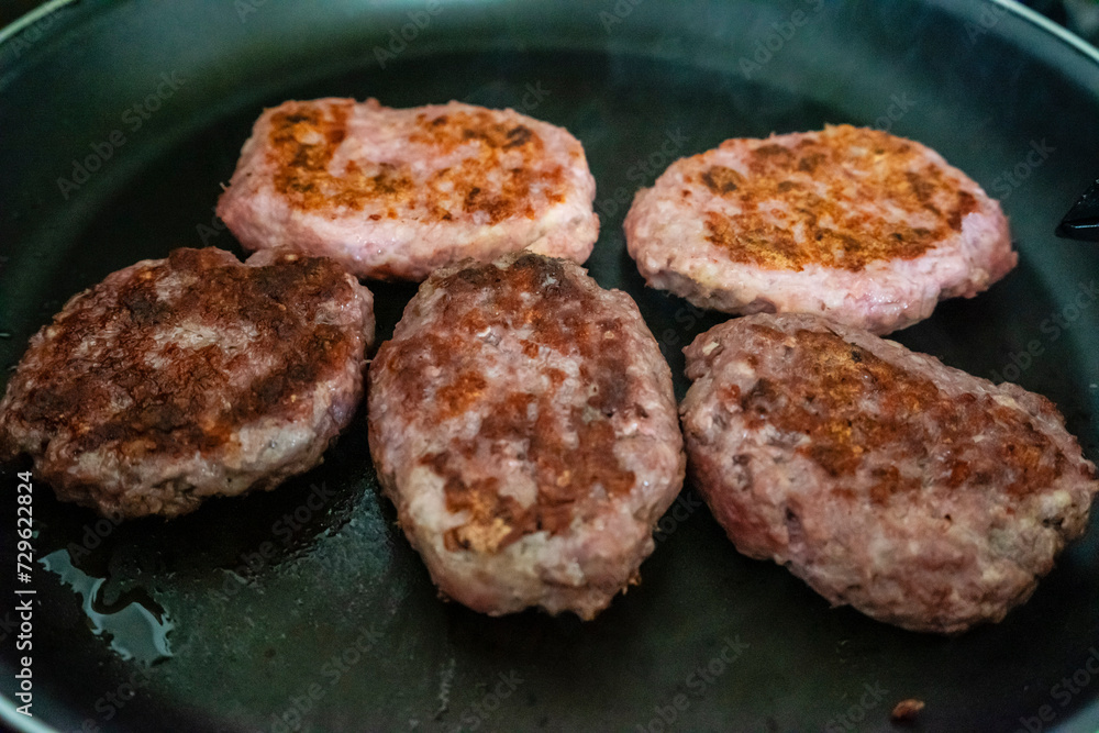 hamburgers toasting on a grill, mallorca, spain hamburgers toasting on a grill, mallorca, spain
