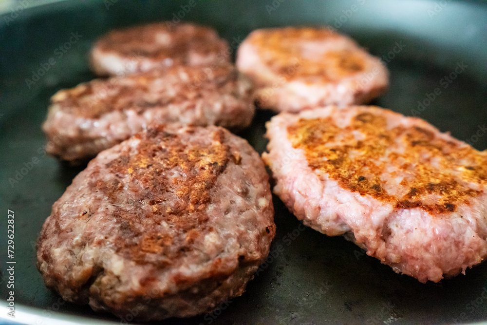 hamburgers toasting on a grill, mallorca, spain hamburgers toasting on a grill, mallorca, spain