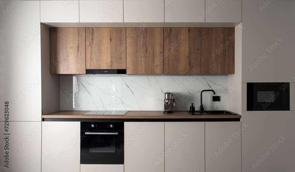 Fototapeta premium Modern built-in kitchen with appliances in a minimalist style