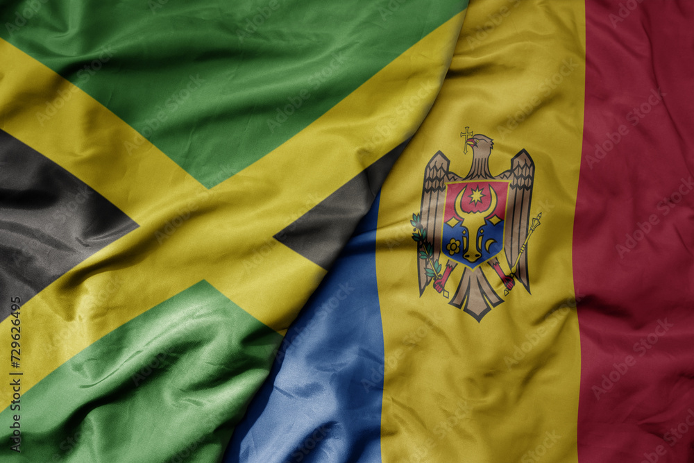 big waving national colorful flag of moldova and national flag of jamaica . big waving national colorful flag of moldova and national flag of jamaica .