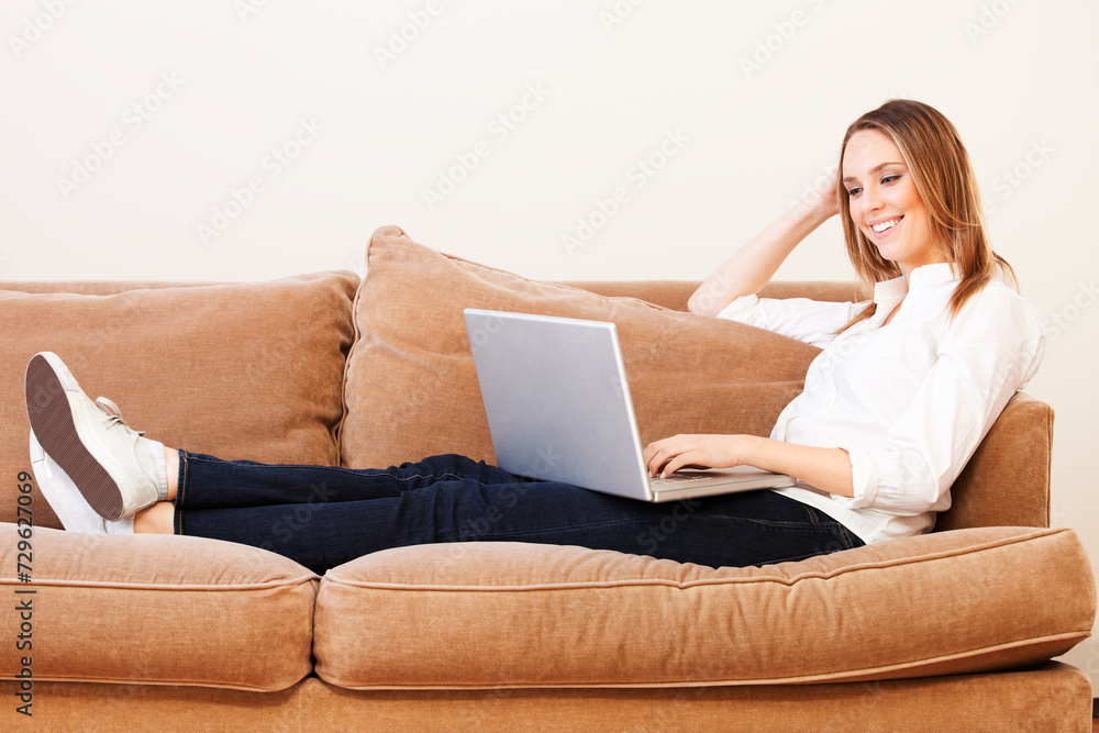 Young Woman with Laptop Computer on Sofa Young Woman with Laptop Computer on Sofa