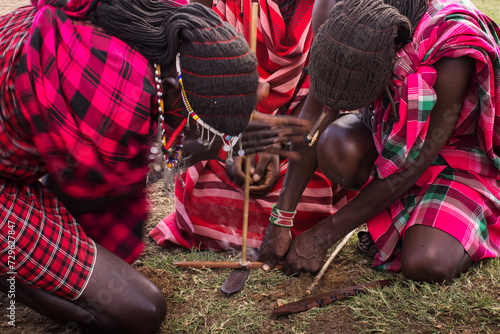 Maasai People making fire in traditional way, Kenya photo
