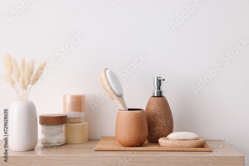 Different bath accessories and personal care products on wooden table photo