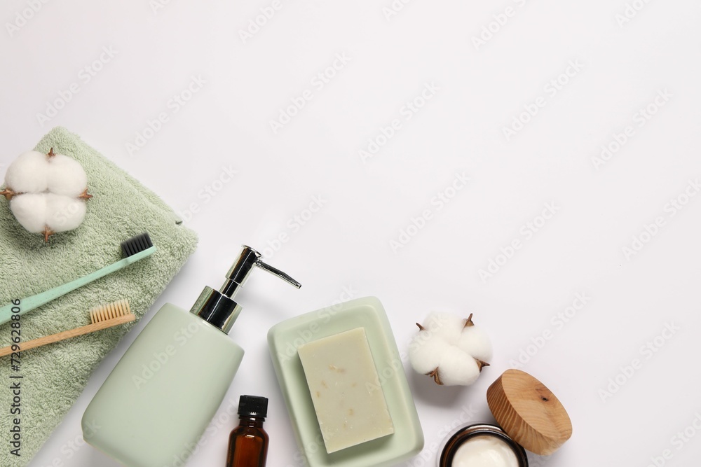 Bath accessories. Different personal care products and cotton flowers on white background, flat lay with space for text Bath accessories. Different personal care products and cotton flowers on white background, flat lay with space for text