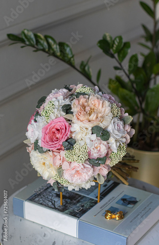 Colorful bridal beautiful bouquet of different flowers. Wedding bouquet of white and pink flowers on the table.