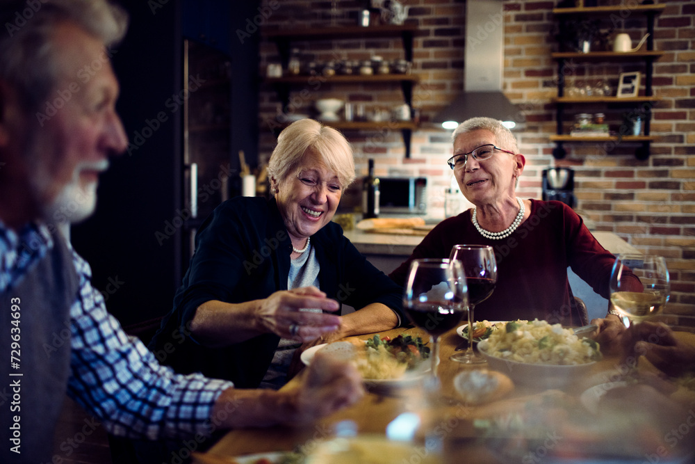 Happy senior people eating dinner together at home Happy senior people eating dinner together at home