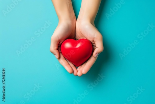 Hands holding red heart Blue background