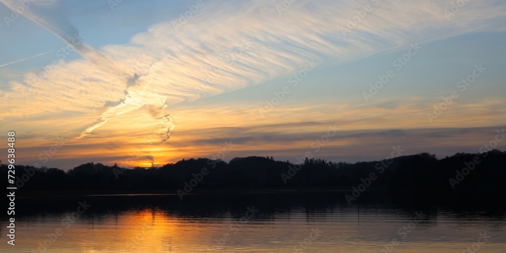 Sunset over the lake with dramatic cloudscape