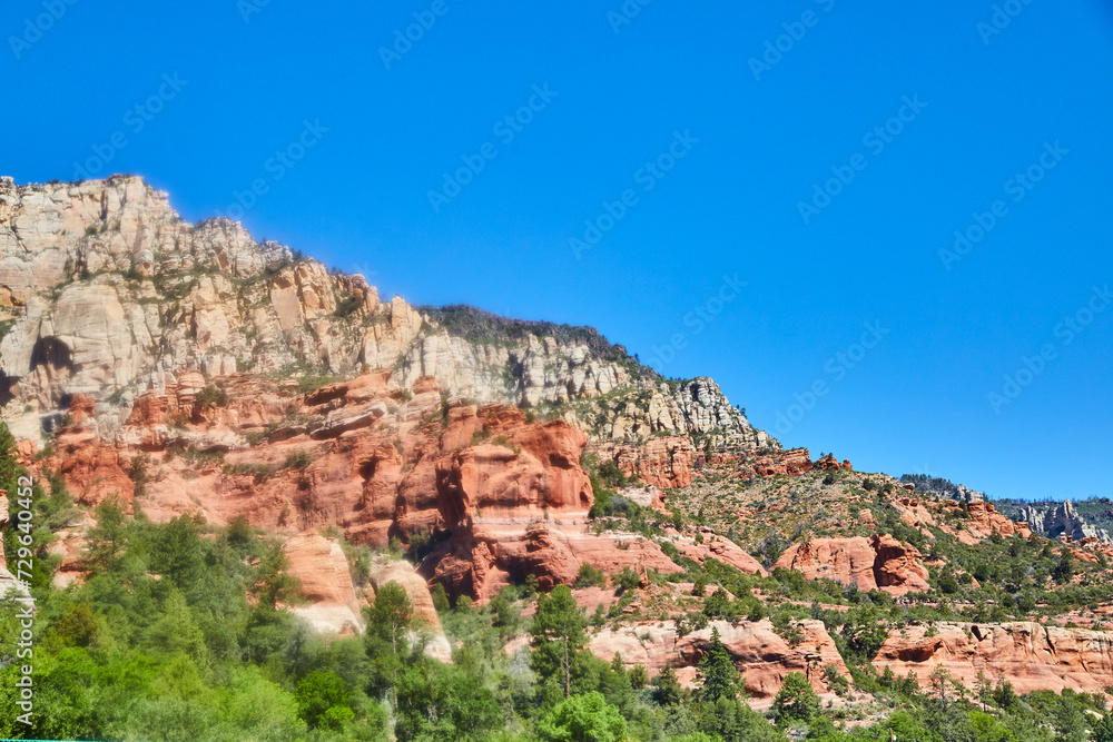 Sedona Red Rock Cliffs and Lush Foliage Under Blue Sky