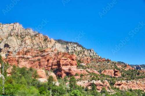 Sedona Red Rock Cliffs and Lush Foliage Under Blue Sky