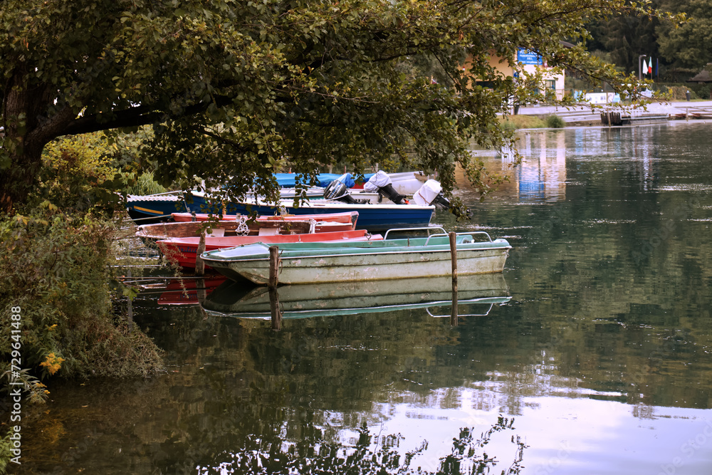 small wooden boats on the Adda river.