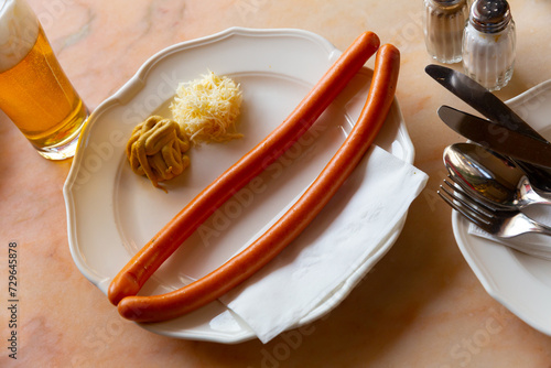 Φωτογραφία Two vienna sausages served with mustard and fresh horseradish on plate