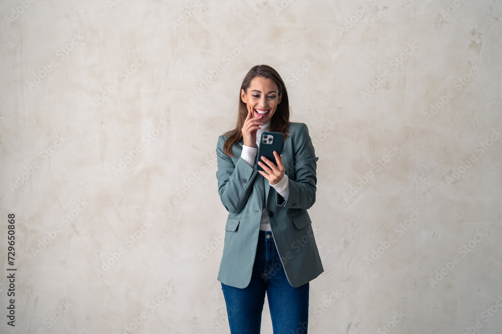 Business woman, studio and smartphone for reading notification, mobile chat and social network. Happy female scroll on cellphone, news app and search digital information on grey background. Business woman, studio and smartphone for reading notification, mobile chat and social network. Happy female scroll on cellphone, news app and search digital information on grey background.