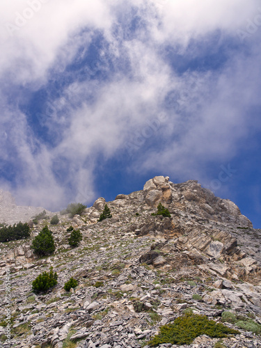 Mountain rocky hillside with blue cloud sky. High quality photo