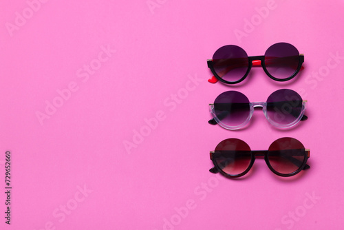luxury fashionable sunglasses on pink and purple background, flatlay top view