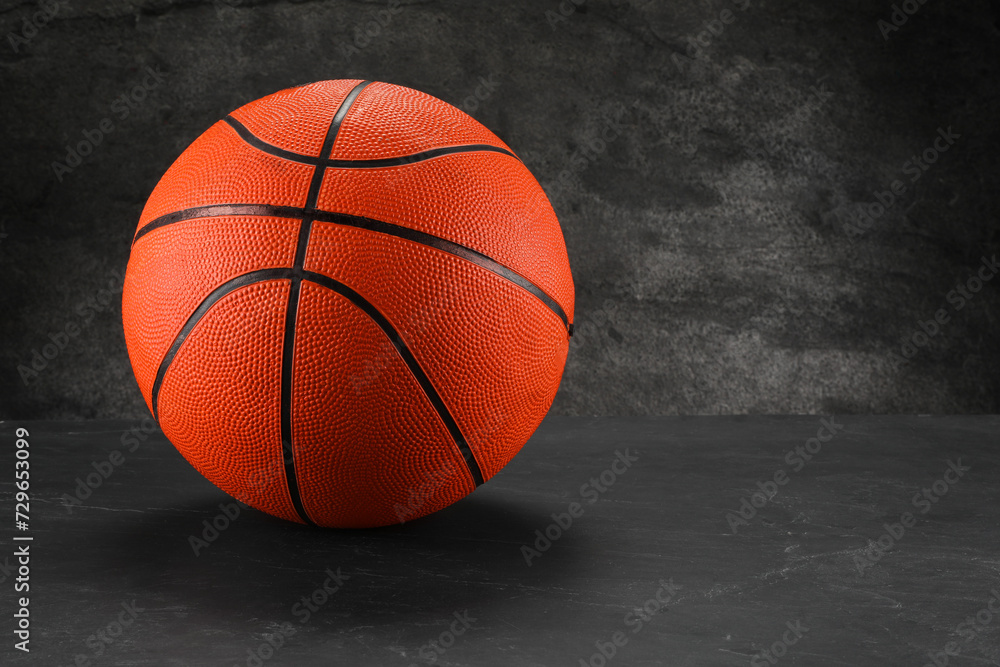 Basketball ball on dark gray background, space for text