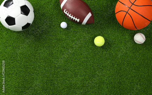 Fototapeta Naklejka Na Ścianę i Meble -  Many different sports balls on green grass, flat lay. Space for text