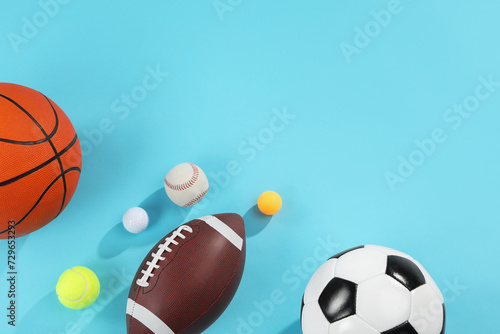 Many different sports balls on light blue background  flat lay. Space for text