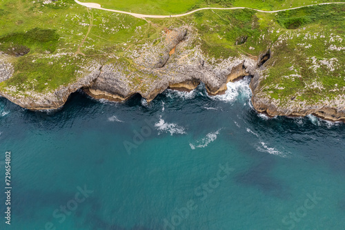 Shore with geological caves made by waves by jesters bufones of arenillas, Spain near city Llanes in August 2023
