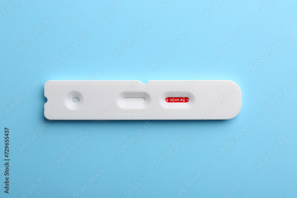 Disposable Covid-19 express test on light blue background, top view Disposable Covid-19 express test on light blue background, top view