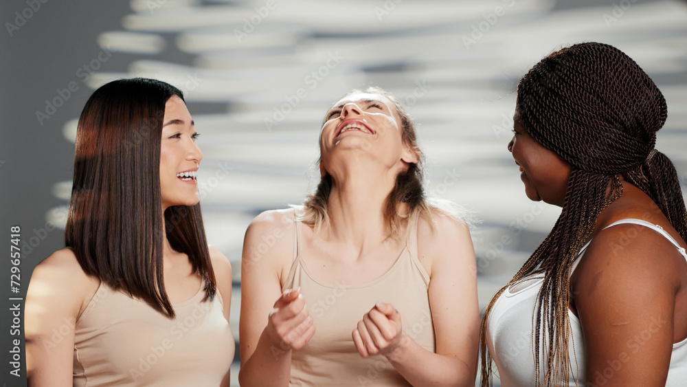 Group of diverse women smiling in body confidence ad, laughing together and promoting body positivity. Young models with radiant skin and different body types showing acceptance. Group of diverse women smiling in body confidence ad, laughing together and promoting body positivity. Young models with radiant skin and different body types showing acceptance.