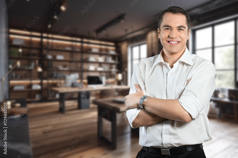 Handsome business man smiling in office background Handsome business man smiling in office background