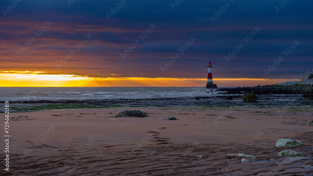 Sunset on Beachy Head lighthouse across Falling Sands, East Sussex