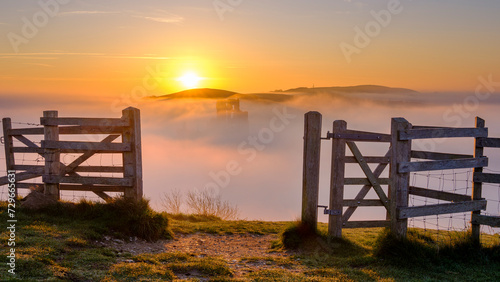 Misty spring sunrise on Corfe Castle, Isle of Purbeck in Dorset, UK