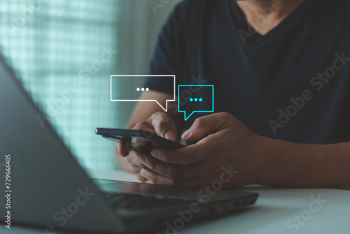 Fototapeta Naklejka Na Ścianę i Meble -  Text Messages, Social media marketing technology concept. People using smartphones typing in response to communication and chat working at home in chat box icons pop up for online customer service.
