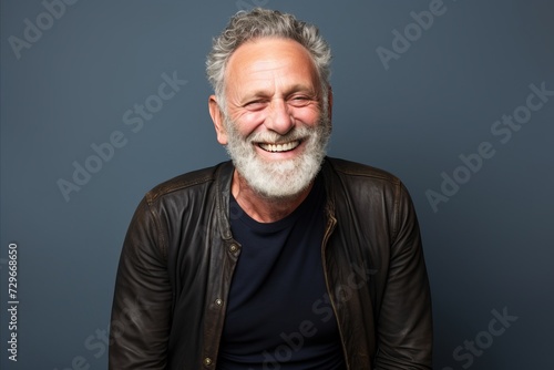 Portrait of a happy senior man with grey hair and beard smiling